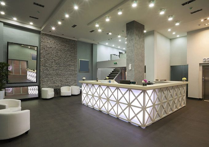 A reception area with a large white counter.